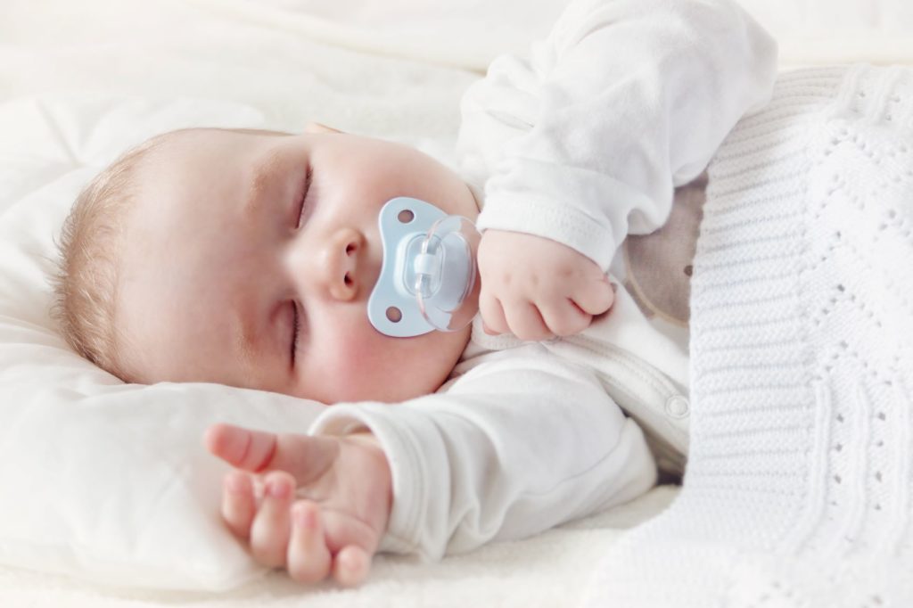 Baby sleeping covered with soft blanket - KKRA - Seattle Wealth Management